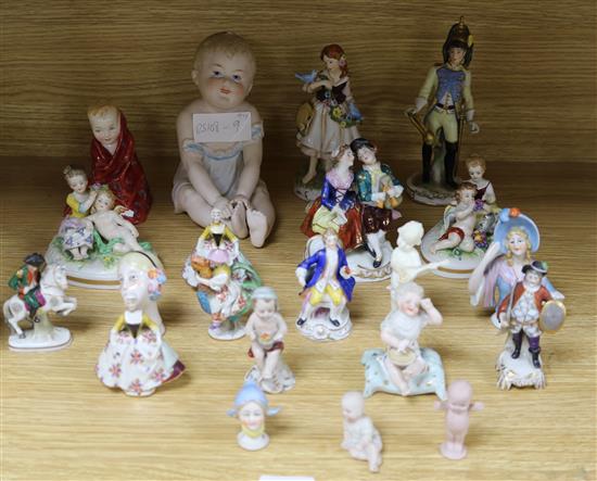 A group of assorted mainly continental porcelain figurines, including a bisque piano baby, 15cm